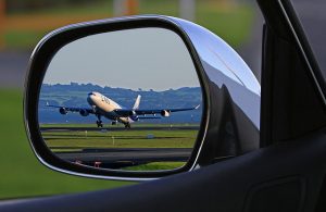 Airport transportation to Castro Valley Airport, seen through drivers mirror. 